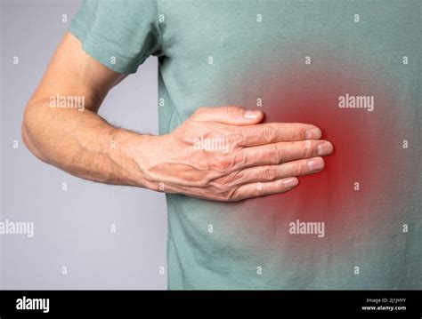 Liver Pain Man Hand Touching Abdomen Right Side With Red Spot Closeup