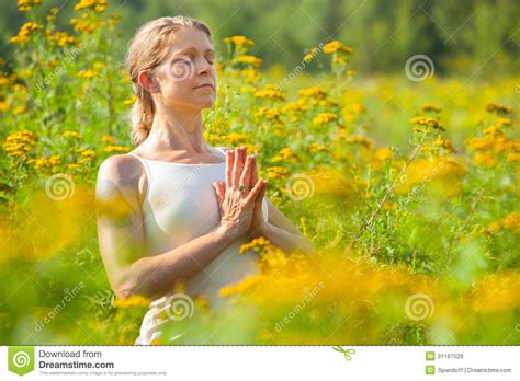 Woman Meditating In Meadow Of Yellow Flowers Stock Image Image Of Body Exercising 31167529