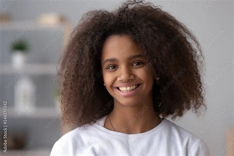 Portrait Of Happy African American Teen Girl Looking At Camera At Home