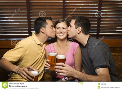 Dois Homens Que Beijam A Mulher Foto De Stock Imagem De Lazer