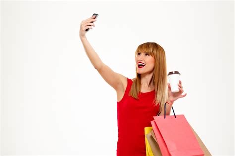 Free Photo Young Beautiful Woman With Purchases Making Selfie Over
