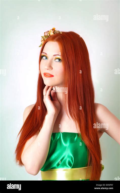 Portrait Of Beautiful Red Haired Girl With Flowers In Her Hair And