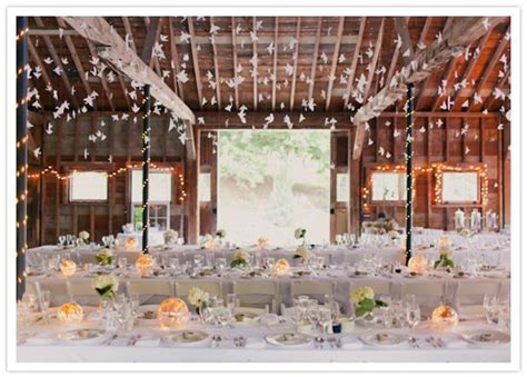 Event planner shannon leahy shares a range of impressive ways couples can deck out the ceiling for their event. hanging paper birds and crisp white linens | Vintage barn ...