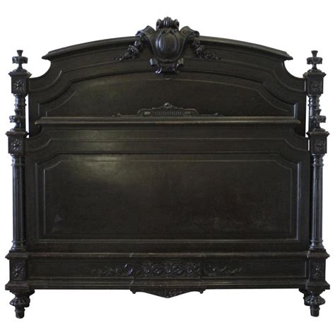 This antique bedroom furniture is reproduction antique furniture the headboard of this beautiful and original antique bed is different from the footboard, consisting of two climbing corners carved in buds, surrounded by acanthus leaves. 20th Century Queen-Size Ebonized Antique Louis XVI Style Bed at 1stdibs