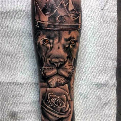 A Mans Leg With A Lion And Rose Tattoo On The Calf Area Which Is