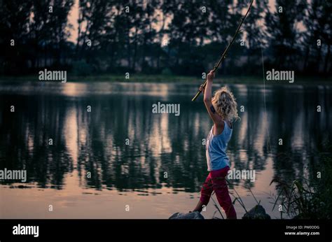 Adorable Little Girl Fishing With Home Made Fishing Rod At The Pond At