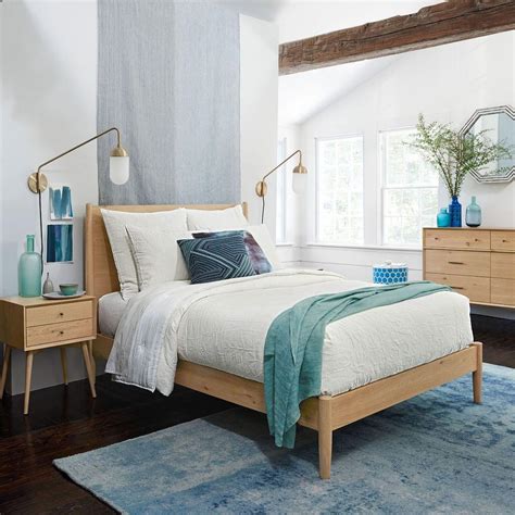 Platform construction, upholstered headboards, and tapered legs galore. Mid-Century Bed - Natural Oak | west elm UK
