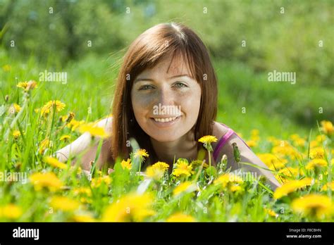 Happy Freckle Woman Relaxing In Dandelion Meadow Stock Photo Alamy
