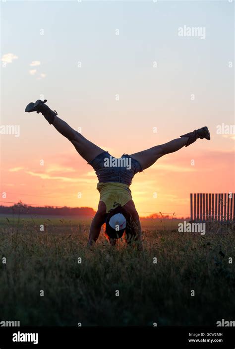 Girl Doing Handstand And Splits In A Field At Sunset Stock Photo Alamy