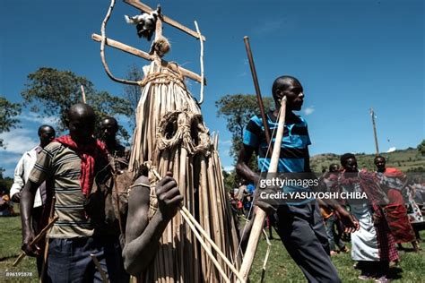 Circumcised Maasai Young Men Wearing A Ritual Costume Covered With