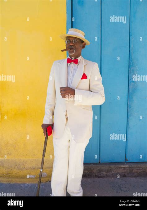 A Dark Elderly Cuban Gentleman In A Straw Boater Hat White Suit Red