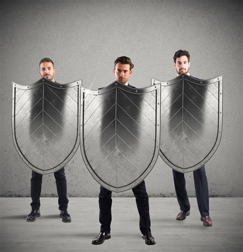 Premium Photo Businessmen With Shields Concept Of Protection And
