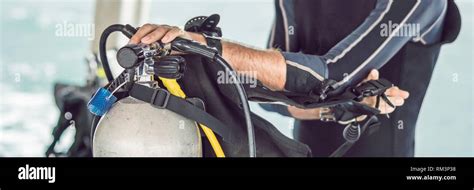 Diver Prepares His Equipment For Diving In The Sea Banner Long Format
