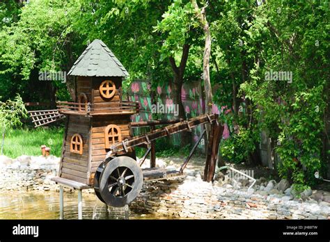 Decorative Wood Water And Wind Mill Situated In Green Park Stock Photo
