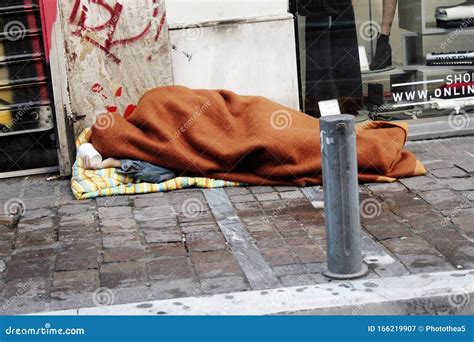 Homeless Person Sleeping On A Street Pavement Editorial Photography