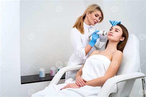Pretty Blonde Beautician Doctor Doing Rf Lifting Procedure For Woman