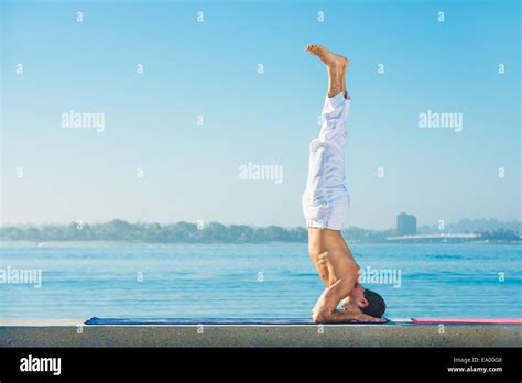 Young Man Practicing Upside Down Yoga Position At Pacific Beach San