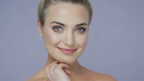 Portrait Of Cheerful Young Pretty Woman Looking At Camera And Touching