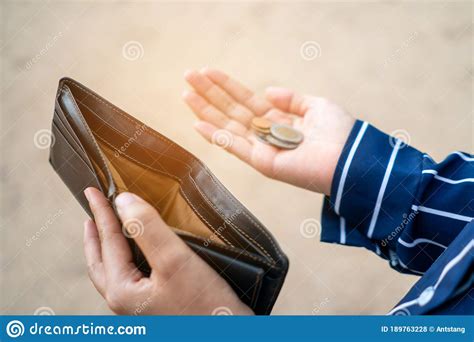 Definition of carried over in the idioms dictionary. Woman Holds An Empty Purse And Coins In Hand Meaning Money ...