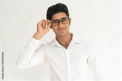 Pensive Smiling Indian Guy Wearing Glasses Handsome Stylish Young Man Touching Eyeglasses And
