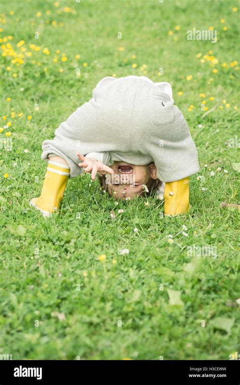 Child Bending Over Waving Through Hi Res Stock Photography And Images