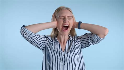 Scared Desperate Woman Screaming And Covering Ears On Blue Background
