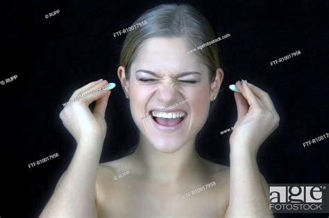 Woman Putting Ear Plugs Stock Photo Picture And Royalty Free Image
