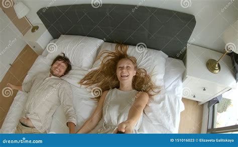 Slowmotion Shot Of A Happy Couple Man And Woman Fall On A Bed Travel