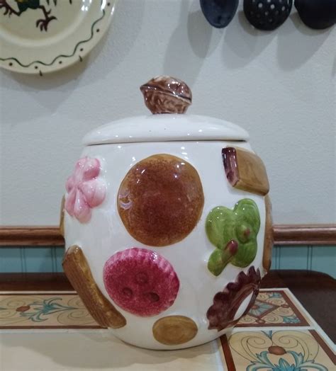 A Ceramic Pot With Colorful Designs On It