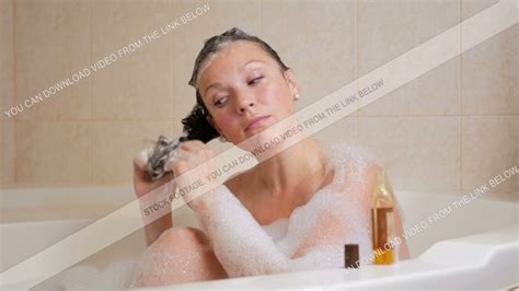 A Young Girl Takes A Bath With Foam And Washing Hair With Shampoo A