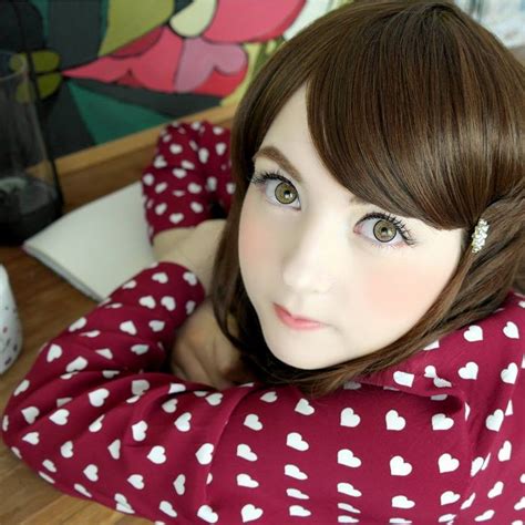 A Close Up Of A Doll Wearing A Red And White Shirt With Hearts On It