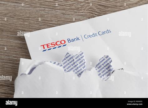 Tesco Bank Credit Card Statement On Table With Ripped Open Envelope