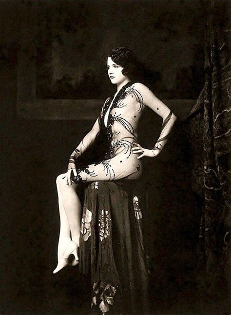 A Woman In A Long Dress Is Posing For The Camera
