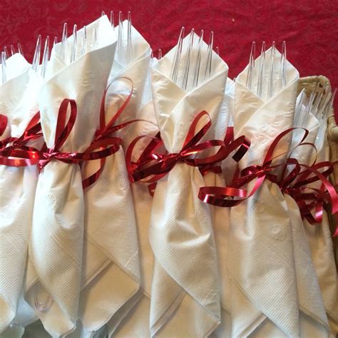 Forks Wrapped With White Napkins Tied With Red Ribbon Red Napkins