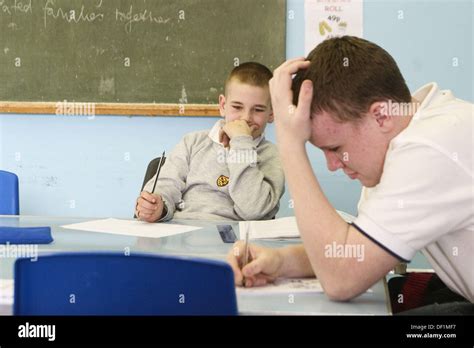 Two 13 Year Old Boys In The Detention Room At School Writing Stock