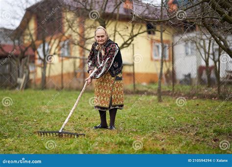 Old Farmer Woman Cleaning With A Rake Stock Photo Image Of Pensioner