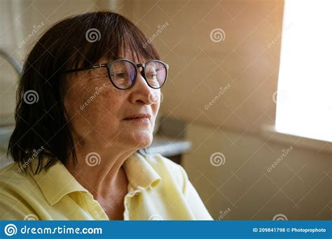 Portrait Of Mature Woman With Glasses Looking To The Side Stock Photo
