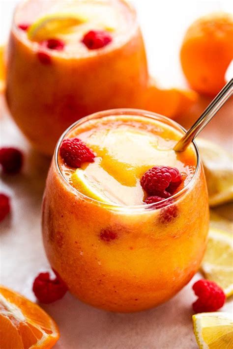 This Beautiful Layered Citrus Raspberry Mango Smoothie Features Vibrant