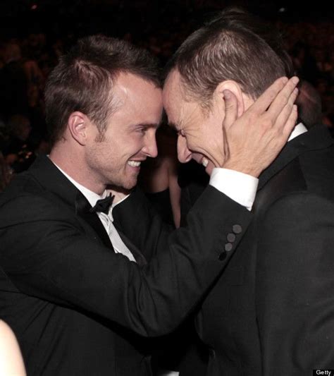 two men in suits are hugging each other
