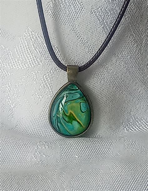 Turquoise Teardrop Necklace In An Antique Bronze Setting Has A