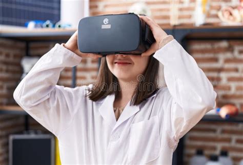 Adorable Hispanic Girl Student Using Virtual Reality Glasses At