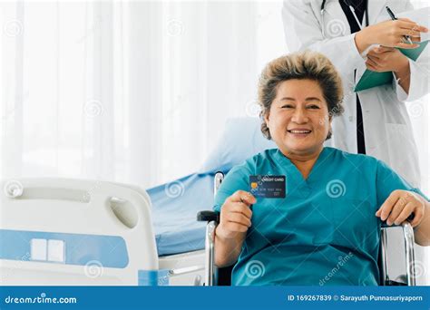 Aged Asian Female Patient Enjoying Commercial Services Of Hospital