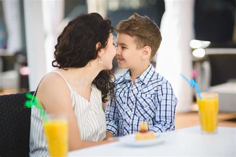 Boy And His Mother Tasting Dessert With Juice In Resort Restaurant Outdoor Stock Photo Image