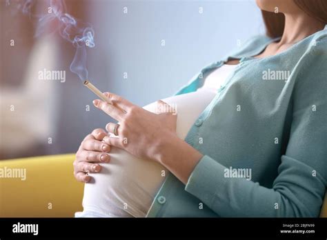 Pregnant Woman Smoking Cigarette At Home Stock Photo Alamy