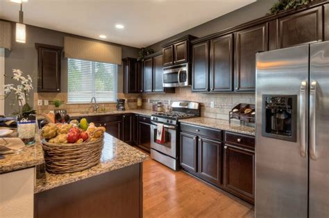 Customers open and close the doors and drawers thousands of times and let their. Dark & light woods used together in this kitchen creates a ...