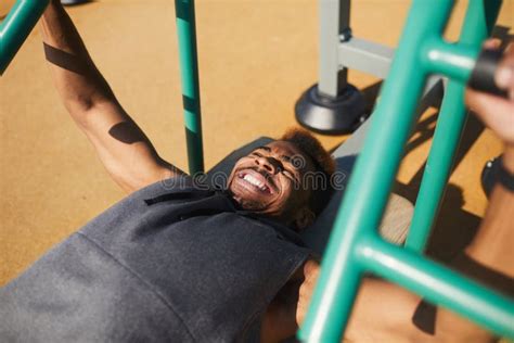 Pushing Up Lying Bearded Powerful Man Lifting A Barbell In A Gym Gym