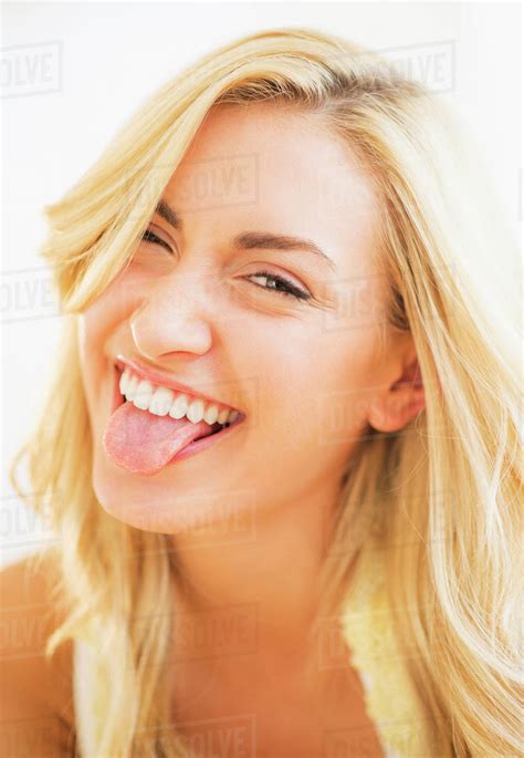 Portrait Of Teenage Girl 16 17 Sticking Tongue Out Stock Photo