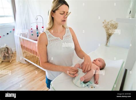 A Mother Changing Babys Diaper In Nursery Stock Photo Alamy
