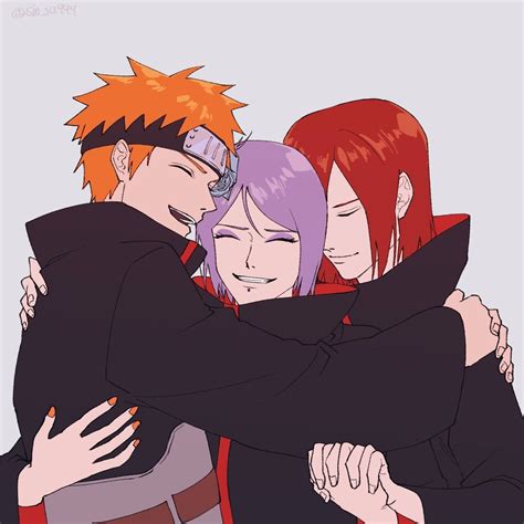 Three People Hugging Each Other With Their Arms Around One Another
