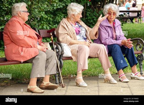 Three Elderly Women Sitting On A Bench In City Park Seniors Aging Old
